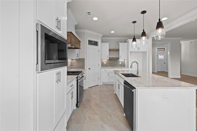 kitchen with sink, stainless steel gas range, dishwasher, white cabinets, and a center island with sink