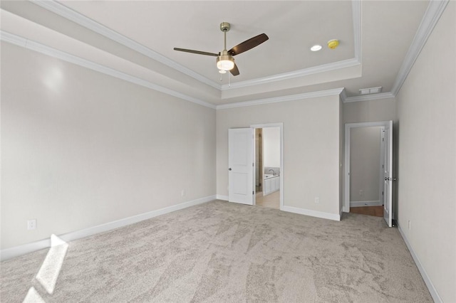 unfurnished bedroom with light carpet, a tray ceiling, ornamental molding, and ceiling fan