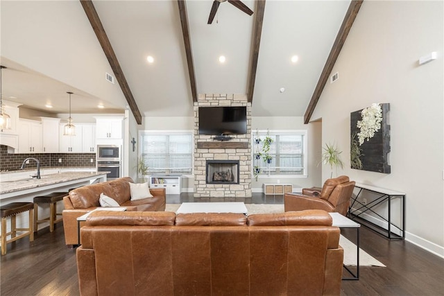 living room featuring dark hardwood / wood-style floors, a fireplace, and beam ceiling