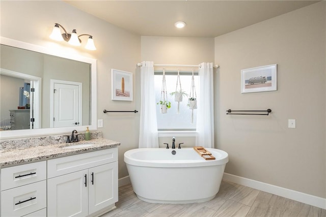 bathroom featuring vanity and a bathing tub