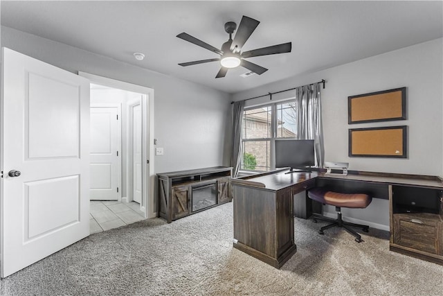 home office with light carpet and ceiling fan