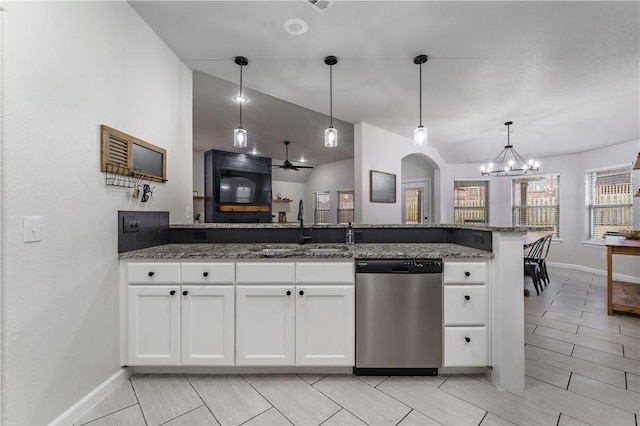 kitchen with dark stone countertops, sink, stainless steel dishwasher, and white cabinets