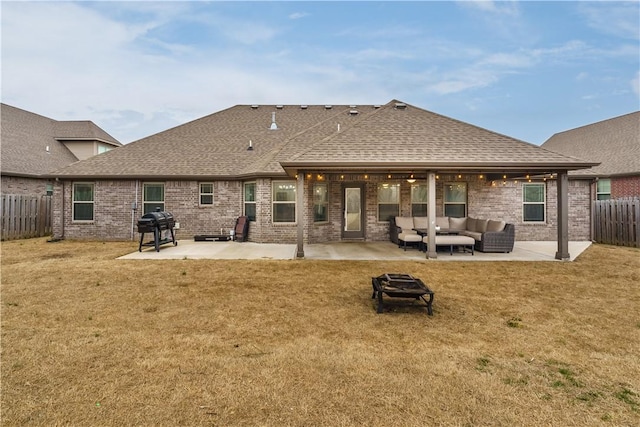 back of house with outdoor lounge area, a patio area, and a lawn