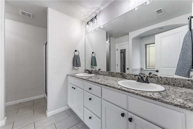 bathroom with vanity and an enclosed shower