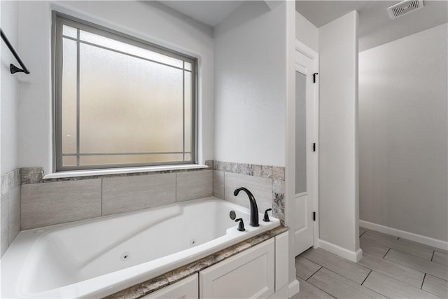 bathroom with tiled bath