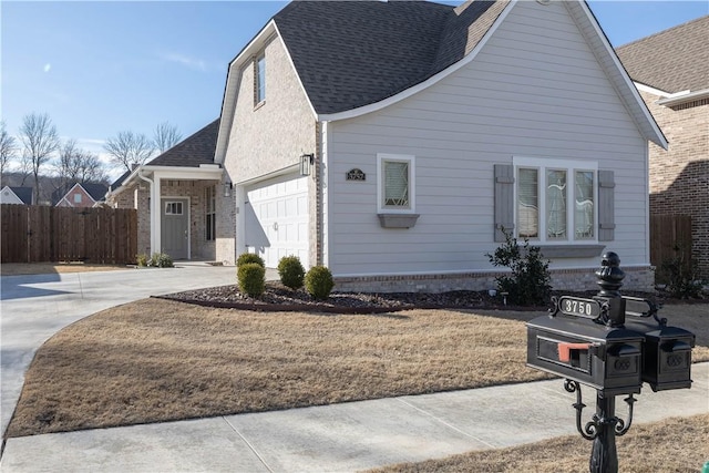 view of side of home with a garage and a yard