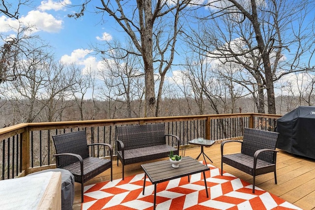 wooden terrace featuring area for grilling and outdoor lounge area