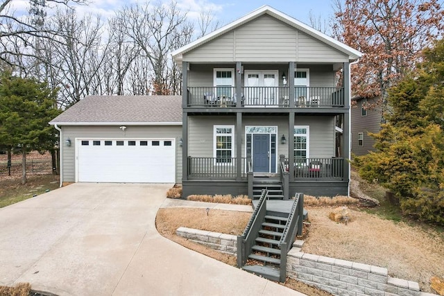 view of front of home featuring a garage, a balcony, and a porch