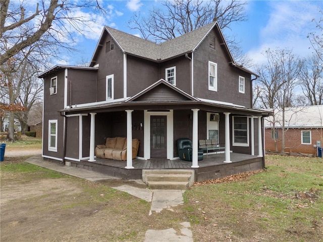 view of front facade with covered porch and a front yard