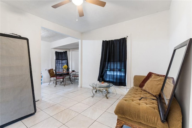 sitting room featuring light tile patterned floors and ceiling fan