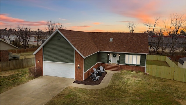 view of front facade with a garage and a yard