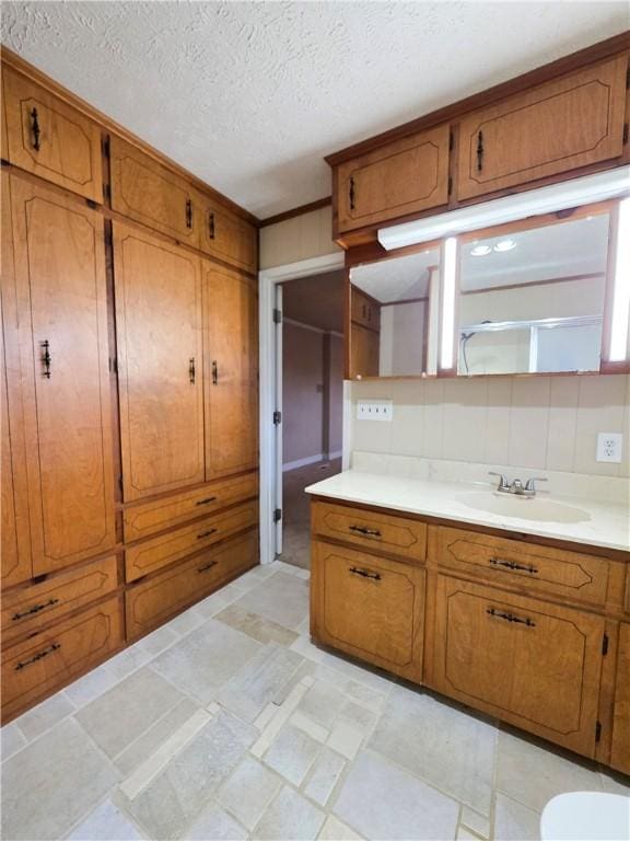 kitchen featuring sink and a textured ceiling