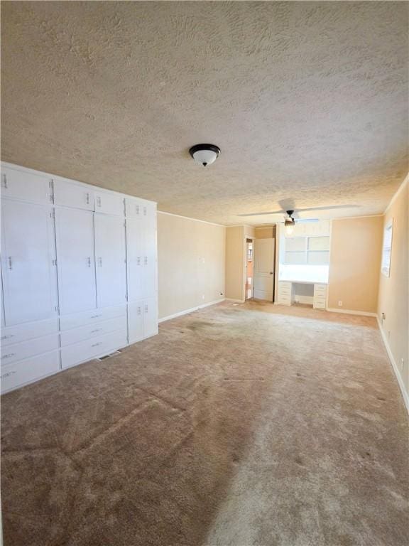 unfurnished bedroom with a textured ceiling and carpet flooring