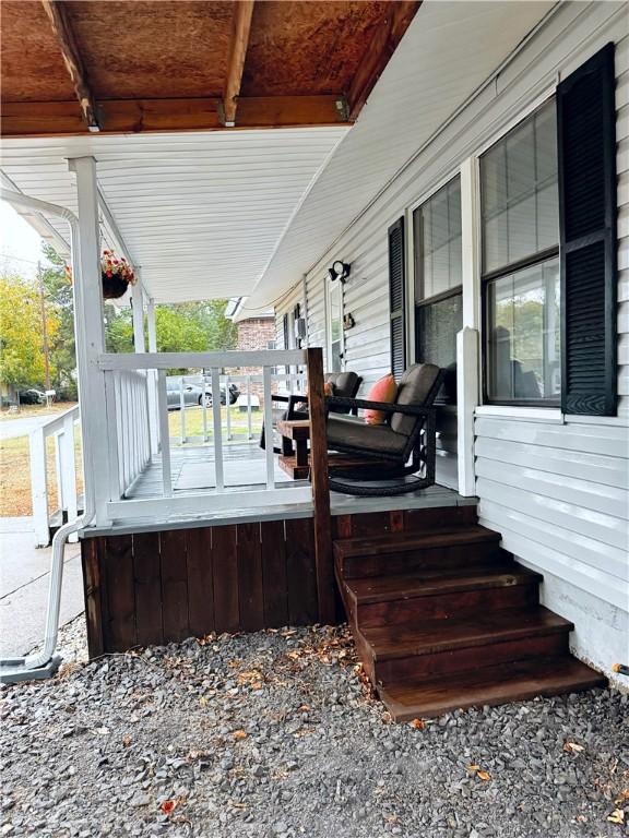 wooden terrace featuring covered porch