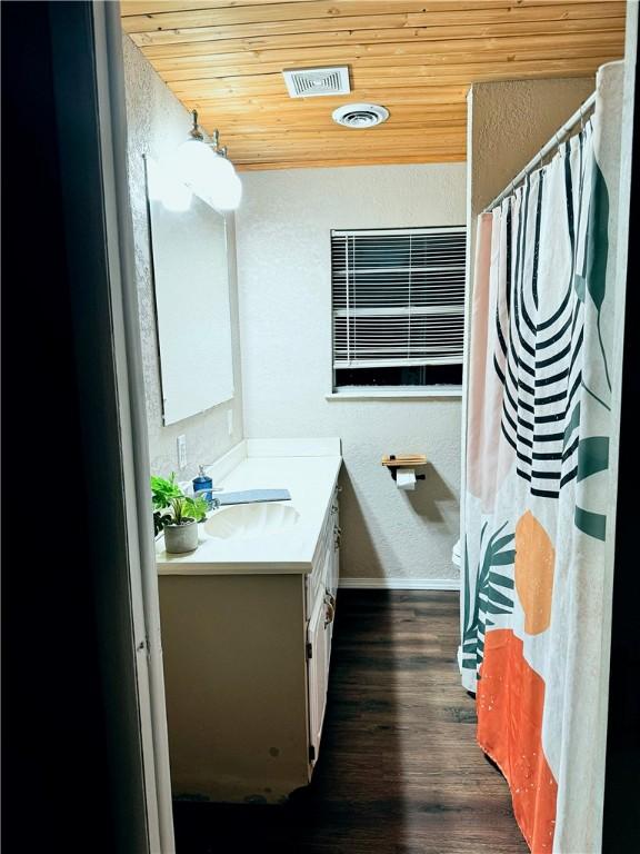 bathroom with wood ceiling, vanity, toilet, and wood-type flooring