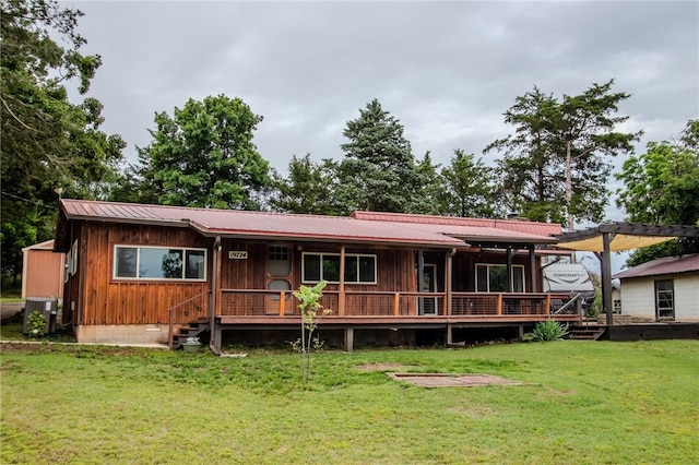 19724 Waldon Rd, Rogers, AR 72756 - rear view of property featuring central AC unit, a lawn, metal roof, and board and batten siding