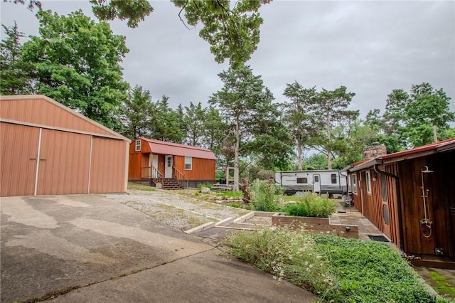 19724 Waldon Rd, Rogers, AR 72756 - view of yard featuring an outbuilding and a garden