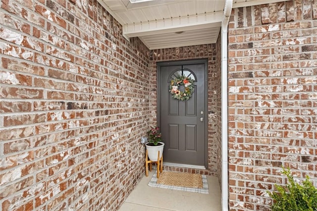 property entrance with brick siding