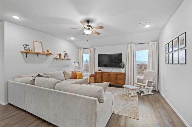 living room with visible vents, baseboards, a ceiling fan, and wood finished floors