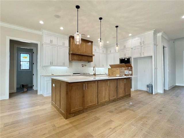 kitchen with light countertops, light wood-style floors, backsplash, and white cabinets