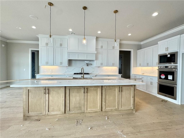 kitchen with a spacious island, backsplash, light countertops, appliances with stainless steel finishes, and white cabinetry