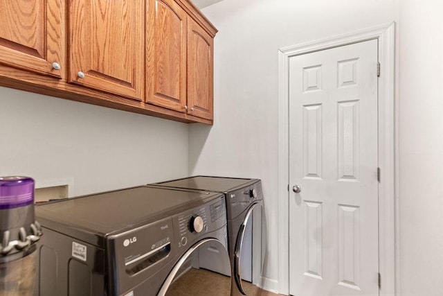 laundry room with cabinet space and washing machine and clothes dryer