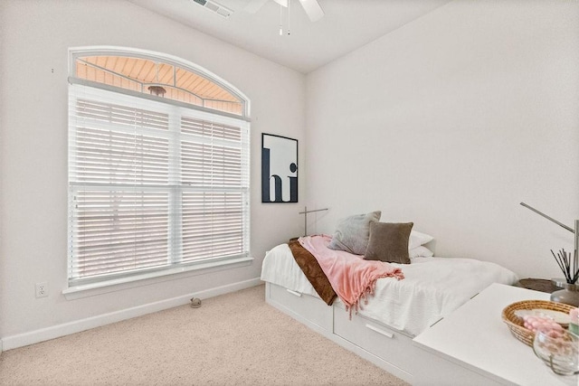 carpeted bedroom featuring baseboards and a ceiling fan