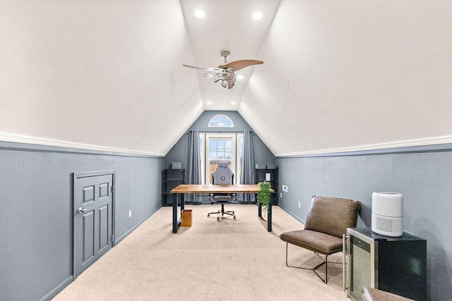carpeted office with lofted ceiling, ceiling fan, and baseboards