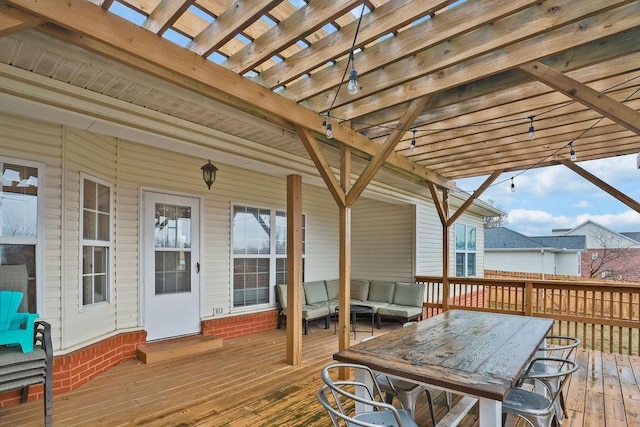 wooden deck with a pergola and an outdoor hangout area