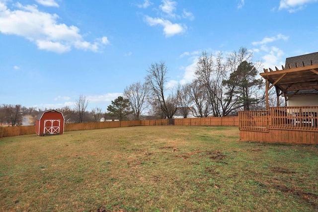 view of yard with a deck, a storage shed, an outdoor structure, and a pergola