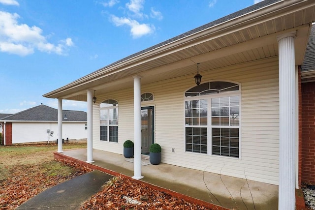 view of exterior entry featuring a porch