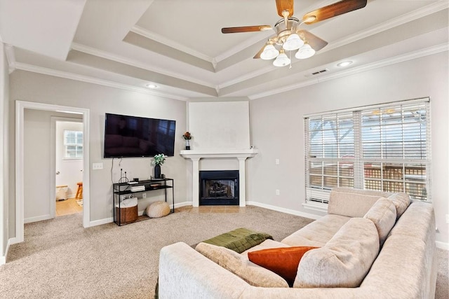 living room featuring healthy amount of natural light, ornamental molding, carpet floors, and ceiling fan