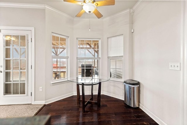dining space featuring baseboards, ornamental molding, hardwood / wood-style flooring, and a ceiling fan