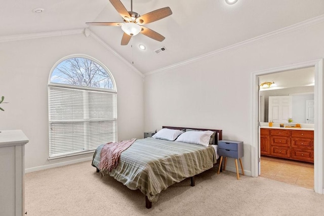 bedroom featuring light carpet, ornamental molding, lofted ceiling, baseboards, and connected bathroom