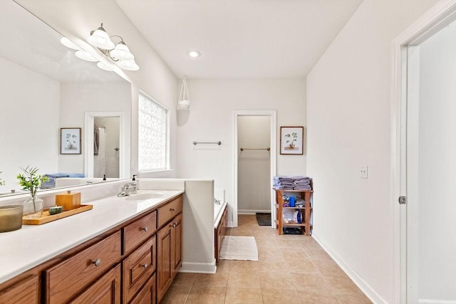 full bathroom with vanity, baseboards, tile patterned floors, a garden tub, and recessed lighting