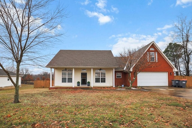 view of front of house with a garage, covered porch, and a front lawn