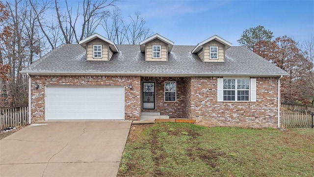 new england style home featuring a garage and a front yard