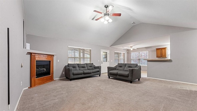 carpeted living room with lofted ceiling and ceiling fan