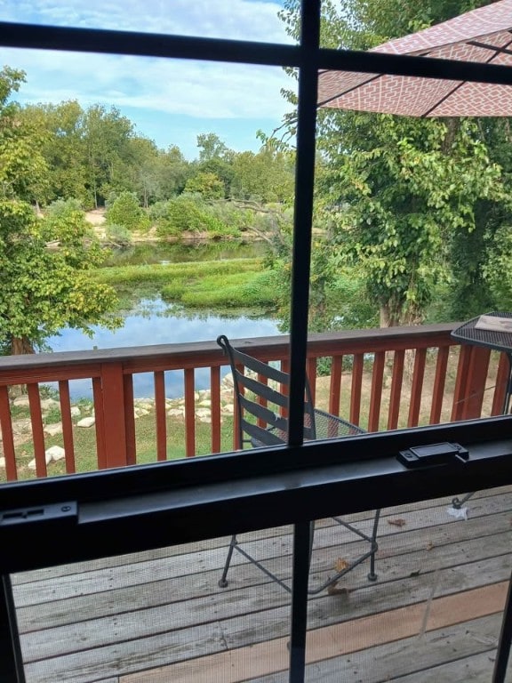 wooden terrace featuring a water view