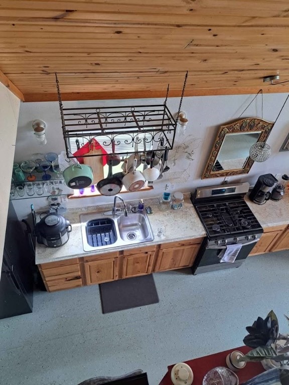 kitchen featuring gas stove, sink, and wood ceiling