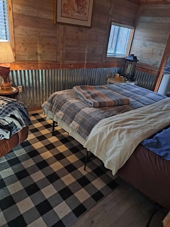 bedroom featuring wooden walls