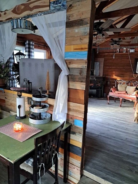 interior space with hardwood / wood-style flooring and wood walls