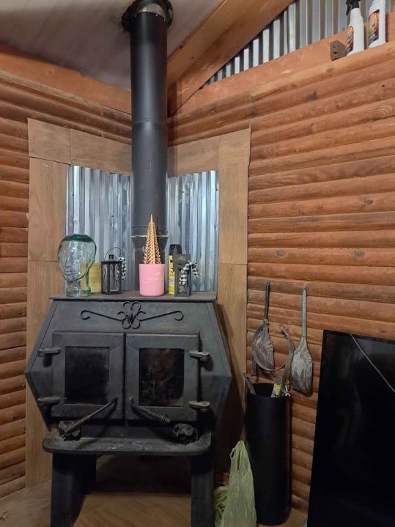 interior details with log walls and a wood stove