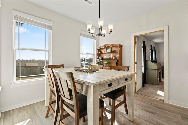 dining area featuring a chandelier and light hardwood / wood-style flooring