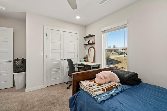 bedroom featuring a closet, ceiling fan, and carpet