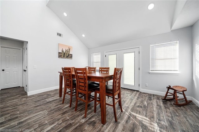 dining area featuring plenty of natural light, dark wood-type flooring, high vaulted ceiling, and french doors