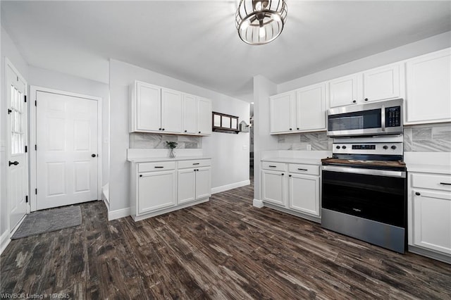 kitchen featuring appliances with stainless steel finishes, white cabinets, and decorative backsplash