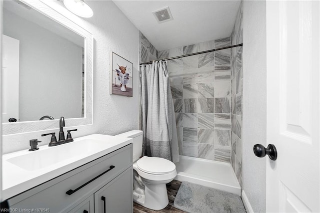 bathroom with vanity, toilet, and curtained shower