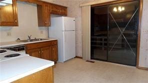 kitchen featuring white fridge and sink