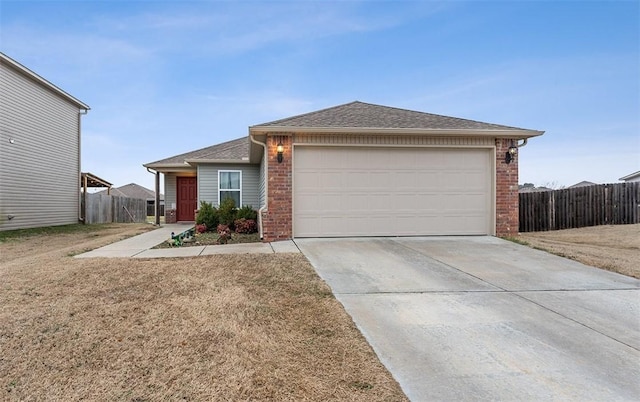 single story home with a garage and a front lawn